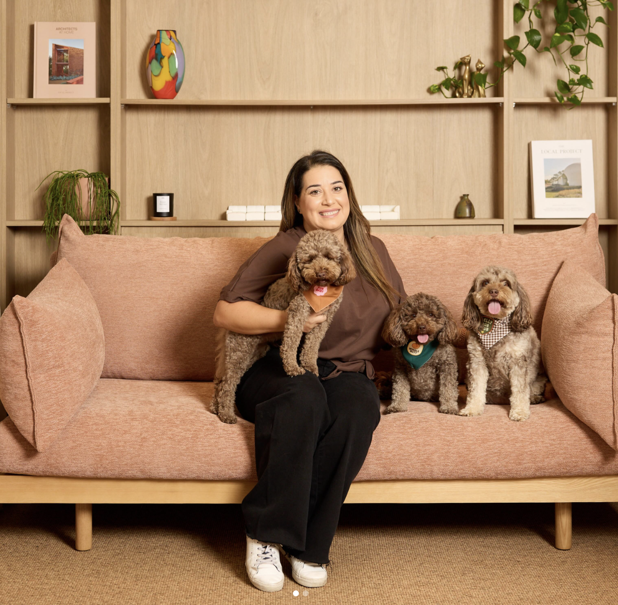 Sara with her dogs on a sofa