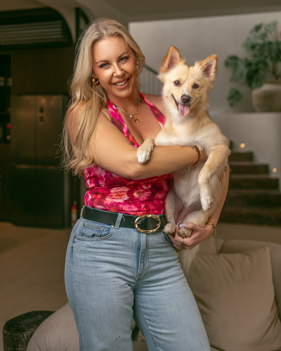 Tatum, founder of Pet PowerHaus, holding a small dog
